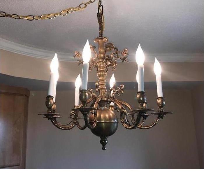 A chandelier that shines and is bronze in color 