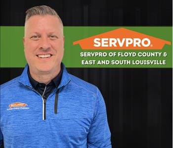 Man standing in front of a SERVPRO sign wearing a black vest
